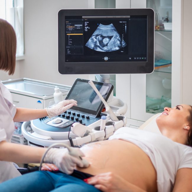 Pregnant woman on utltrasonographic examination at hospital.